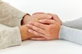 Close up of old man and young woman holding hands Royalty Free Stock Photo