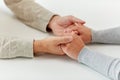 Close up of old man and young woman holding hands Royalty Free Stock Photo