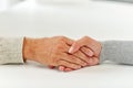 Close up of old man and young woman holding hands Royalty Free Stock Photo