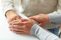 Close up of old man and young woman holding hands Royalty Free Stock Photo