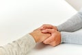 Close up of old man and young woman holding hands Royalty Free Stock Photo