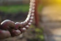 Close-up Old metal chain on fence background in the sunlight Royalty Free Stock Photo