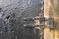 Close up of an old metal door and hinge Royalty Free Stock Photo