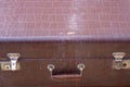 retro metal latch and handle on a brown closed suitcase close up