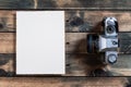 Close-up of an old 35mm camera on ancient wood background Royalty Free Stock Photo