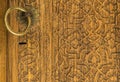 Close up an old ornate wooden door with beautiful carvings and handle in Bukhara, Uzbekistan Royalty Free Stock Photo