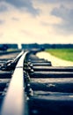 Close up of an old rail with stormy clouds duo toned
