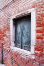 Close up old red brick wall building with shutters window concept photo. Street scene, Royalty Free Stock Photo