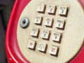 Close up of old retro red phone keypad. Analog dial pad of old phone. Royalty Free Stock Photo