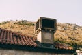 A close-up of an old rooftop chimney overlooking a wasteland. Royalty Free Stock Photo