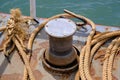 Close up of Old ropes and rusty bollard. rope and Marina bollard on moorage. The concept of mooring and water transportation Royalty Free Stock Photo