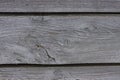 Close-up of an old rough planked wooden barn wall. Vintage detailed vintage wooden background