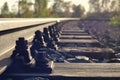 Close-up of old rusted rail with nuts, bolts and wethered wooden sleepers