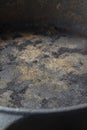 Close up of an old rusty cast iron frying pan background.