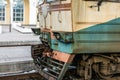 close-up Old rusty diesel train locomotive at railway station. Outdated technology cargo transport vehicle