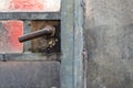 Close up of a old rusty door handle on a glass door in a abandoned greenhouse Royalty Free Stock Photo