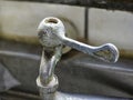 Close up of the old rusty faucet on the kitchen counter. Royalty Free Stock Photo