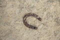 Close-up of an old rusty horseshoe propped on a big stone. Royalty Free Stock Photo