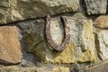 Close-up of an old rusty horseshoe propped on a big stone. Royalty Free Stock Photo