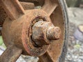 Old rusty iron wheel on the street in the city Royalty Free Stock Photo