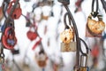 close up old rusty locks heart shaped on wire rope. Love lock on the bridge. tradition of hanging a barn lock on the