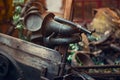 Close up old rusty retro car horn and other vintage items lying in a heap and waiting for their museum restoration. Selective