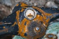 Close-up of an old rusty steering wheel of a two-wheeled motorcycle with a broken speedometer. Royalty Free Stock Photo