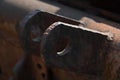 Close-up of an old rusty traverse of a rotten tow truck with two metal eyelets