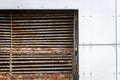 Old rusty ventilation grill in a new white wall Royalty Free Stock Photo