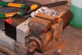 Close-up of an old rusty vise with tools and other objects on a wooden surface Royalty Free Stock Photo