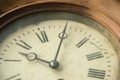 Close-up of an old shabby retro clock, the time is almost midnight. Concept of time, past or deadline Royalty Free Stock Photo