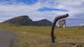 CLOSE UP: Old sign hanging off a stump points towards the Rano Raraku crater. Royalty Free Stock Photo