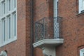 a Close-up of an old, small, empty balcony with a pretty metal railing on an old apartment building Royalty Free Stock Photo