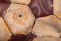 Close-up of an old soccer ball on the leg on a white table. Leather and destroyed ball without air Royalty Free Stock Photo