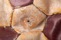 Close-up of an old soccer ball on the leg on a white table. Leather and destroyed ball without air Royalty Free Stock Photo