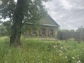 Close up of old soviet house in countryside. Small one-story house in village in summertime. Royalty Free Stock Photo