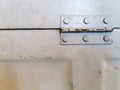 Close up old steel white door or window hinge with copy space