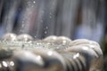 Close-up of an old stone fountain with dripping water and blurred background Royalty Free Stock Photo