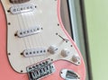 close up of an old style pink electric guitar. Details of rock guitar. Royalty Free Stock Photo