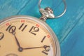Close up of old style pocket watch on blue wooden backround Royalty Free Stock Photo