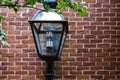 Close-up of old style street lamp in front of the red brick wall Royalty Free Stock Photo
