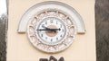 Close up of old tower of beige color with white clock dial surrounded by signs of zodiac. Stock footage. Architectural Royalty Free Stock Photo