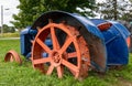 Close up of an old tractor trailer, orange wheel frame, farm Royalty Free Stock Photo