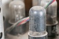 Close-up of old tube radio components, with dusty translucent circuits in a blurred electronics setup. m Royalty Free Stock Photo