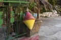 Close-up of an old two-color red and yellow marine buoy hanging near coastal fishing boats. Tools for fishing Royalty Free Stock Photo