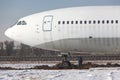 Close up of old unused large passenger plane on a snowy field Royalty Free Stock Photo