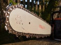 Close up of old used chainsaw blade and chain with sharp teeth, tool for wood cutting, lumberjack professional equipment