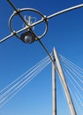 Close up of the old Victorian lights on the pier at southport with the tower of the modern suspension bridge against sky