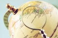 Close up of old vintage globe and magnifying glass Royalty Free Stock Photo