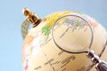 Close up of old vintage globe and magnifying glass. Royalty Free Stock Photo